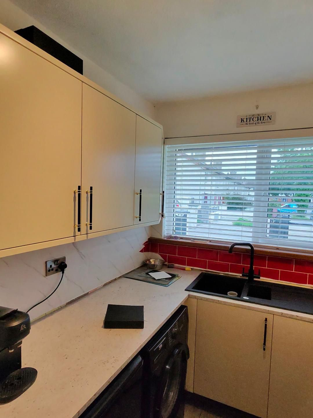 Fitted kitchen with light cabinet doors and pale worktops, view 8 of 13