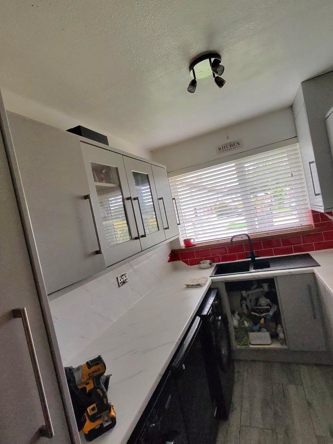 Fitted kitchen with light cabinet doors and pale worktops, view 13 of 13